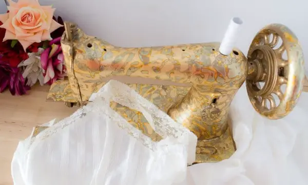 Use gold leaf and adhesive spray to decorate an old sewing machine